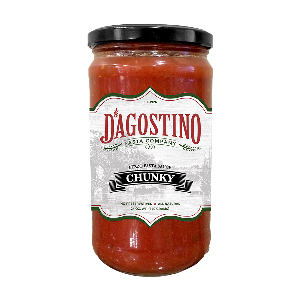 Close up of a glass jar full of red Dagostino Chunky Tomato Sauce.