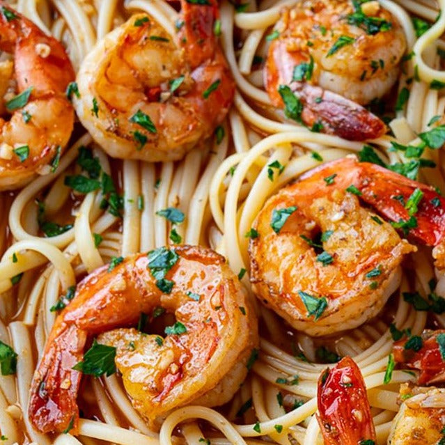 Close up of cooked Dagostino Linguine Pasta topped with Cajun BBQ Shrimp Scampi 