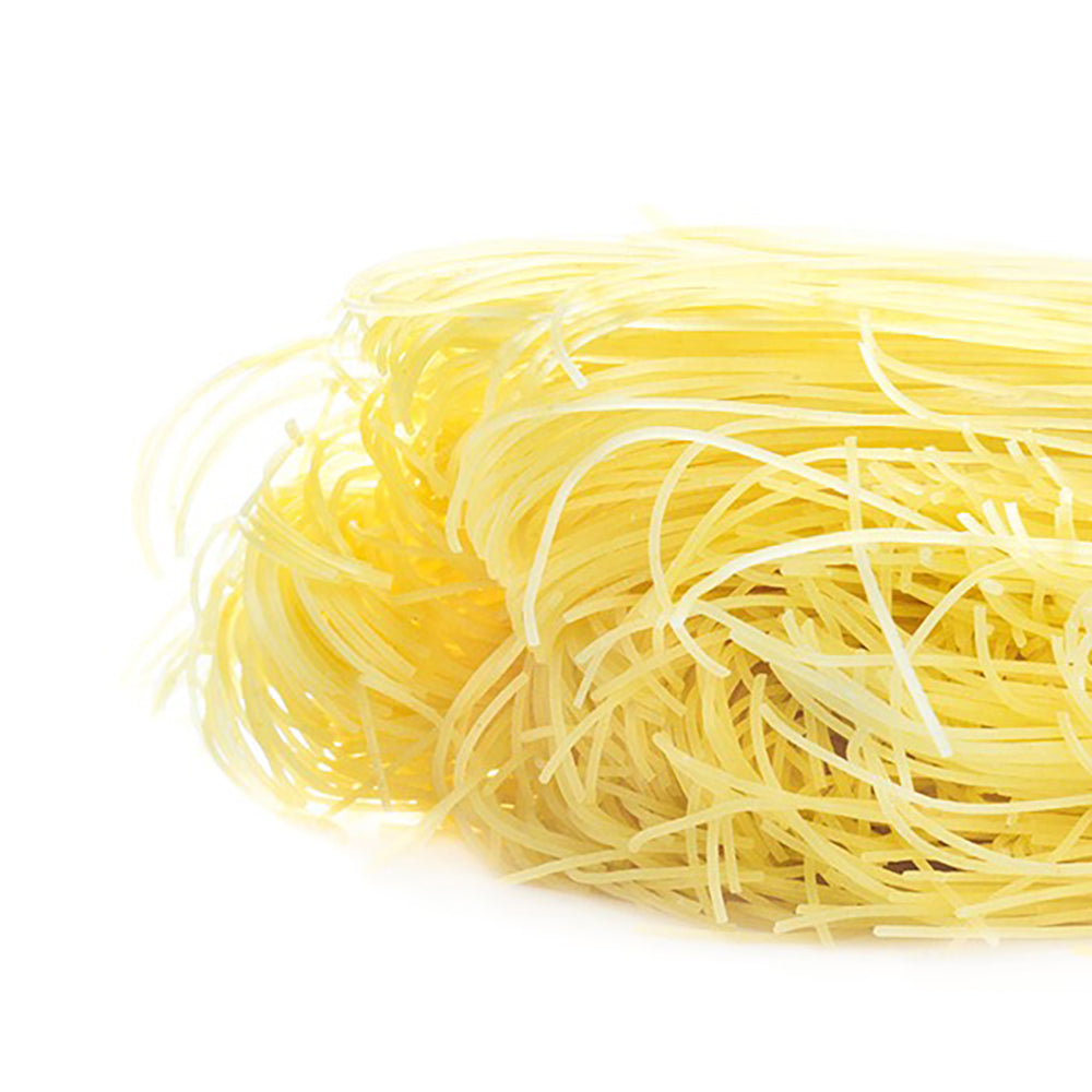 Close up of a pile of dried Dagostino Vermicelli Pasta against a white background.